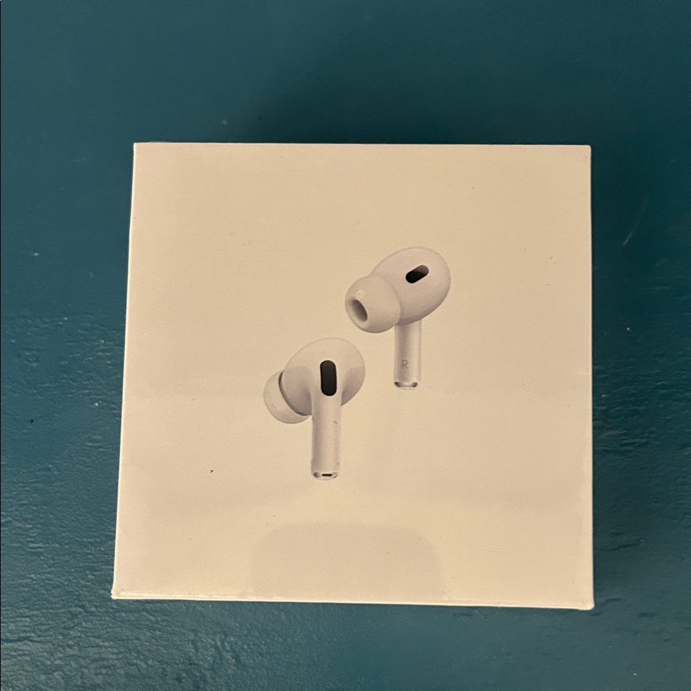 Apple White Earbuds Box on Teal Surface